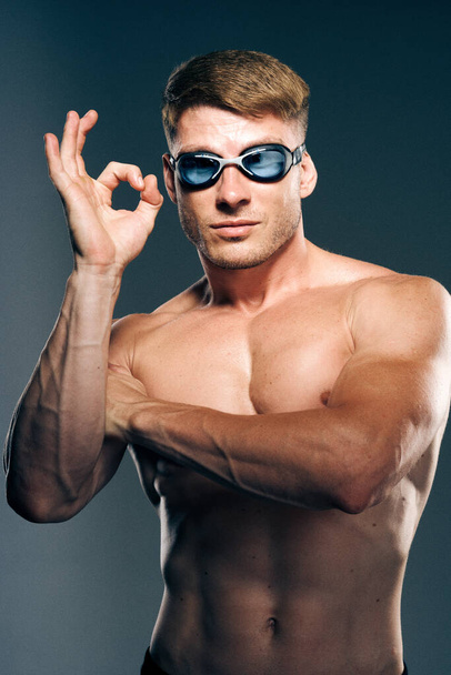 sports man with naked torso swimmer professional dark background - 写真・画像