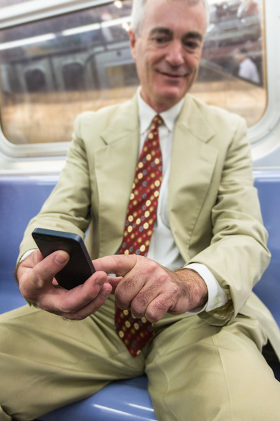 Senior Businessman Using Mobile Phone in the Subway Train - Photo, Image