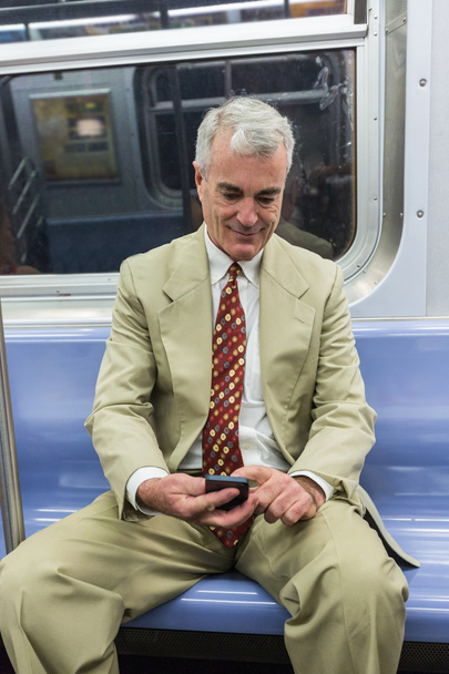 Senior Businessman Using Mobile Phone in the Subway Train - Photo, Image