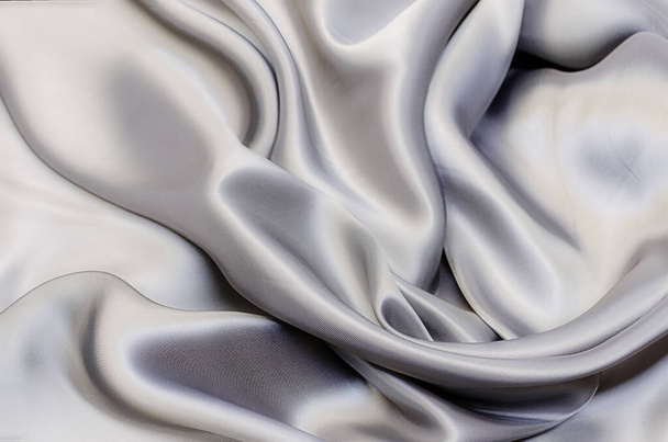 Close-up texture of natural gray or black fabric or cloth in same color. Fabric texture of natural cotton, silk or wool, or linen textile material. Black canvas background. - 写真・画像