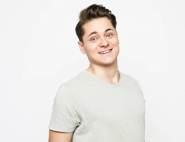 Close-up portrait of handsome adult man with beaming smile, looking camera satisfied, feel upbeat and enthusiastic, standing white background cheerful, enjoying the day, feel excitement - Foto, afbeelding