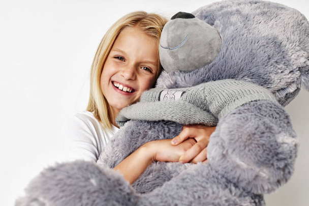 Маленькая милая девочка плюшевый медвежонок в руках весело детей концепция образа жизни - Фото, изображение