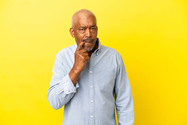 Cuban Senior isolated on yellow background nervous and scared - Foto, Imagen