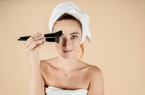 pretty caucasian woman beauty treatment makeup brush towel on head - Foto, immagini