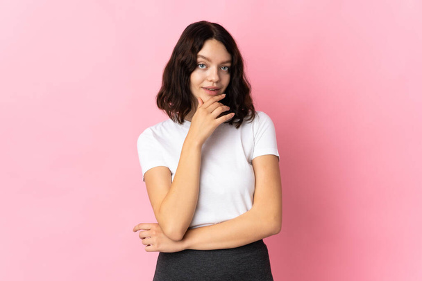 Teenager Ukrainian girl isolated on pink background thinking - Valokuva, kuva
