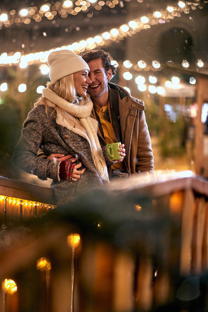 Romantic man and woman in Christmas night together  - Фото, изображение