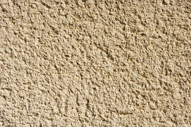 Light yellow rough plaster on wall closeup  - Фото, зображення
