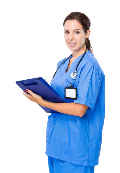 Female doctor write on clipboard - Foto, afbeelding