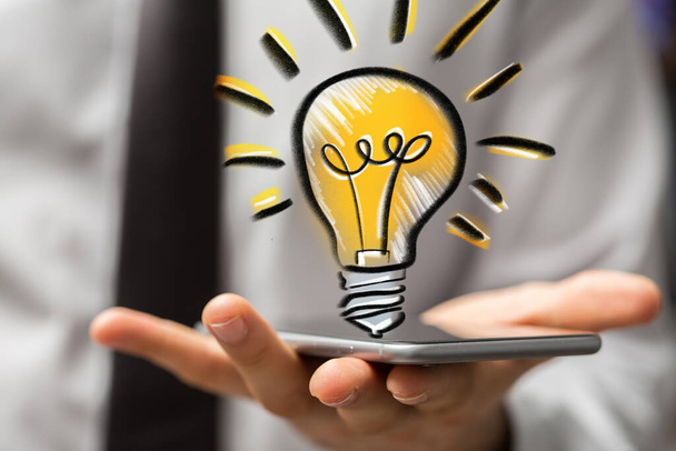 A 3D rendering of floating light bulb icon on a businessman's hand - new idea concept - Φωτογραφία, εικόνα