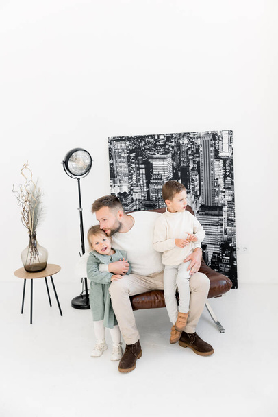 happy father  with children sitting on  chair  - Φωτογραφία, εικόνα