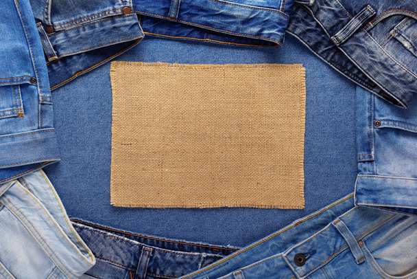 Blue jeans denim background and burlap hessian sacking texture. Jeans fabric material - Фото, изображение