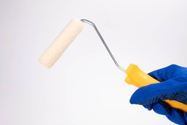 paint roller with yellow grip on a white background. - Fotoğraf, Görsel