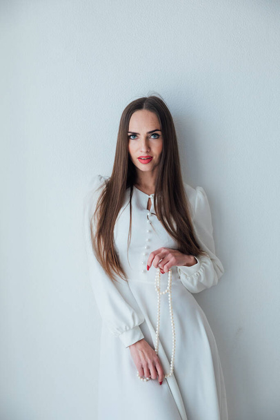 portrait of a beautiful woman in a white light dress - Fotoğraf, Görsel