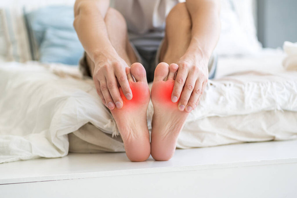 Foot pain, man suffering from feet ache at home, podiatry concept - Фото, зображення