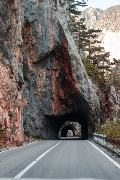 Empty route and small tunnel in mountain - 写真・画像