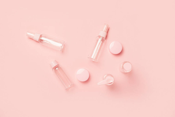 Empty tubes for cosmetics on a pastel pink background. Flat lay, top view. Banner. - Фото, зображення