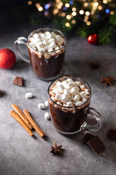 Glass mug with hot chocolate cocoa drink with marshmallow. Copy space. Dark background. Low key. Winter, Christmas and New Year food and drink concept. Selective focus. - Photo, image