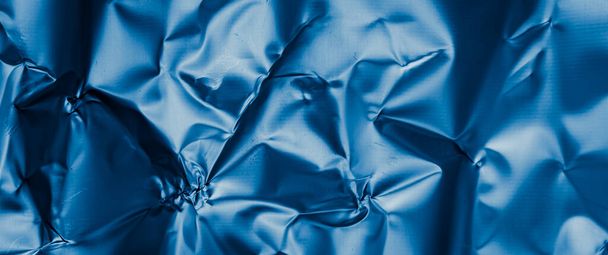 crinkled blue foil with visible details. background or texture - Foto, afbeelding