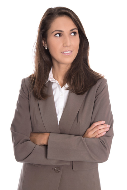 Sceptically isolated business woman in brown blazer looking side - 写真・画像