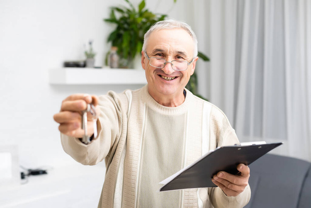 Worried senior man with tax documents at home - Zdjęcie, obraz