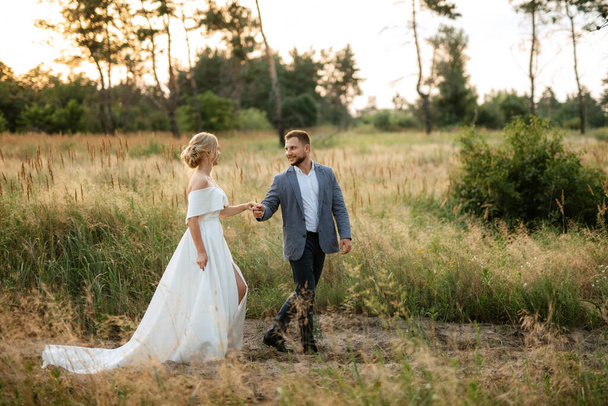 bride and groom on a walk in the woods - Foto, immagini