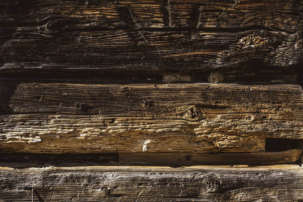 Closeup picture of old rustic wooden planks eaten by caries - Photo, Image