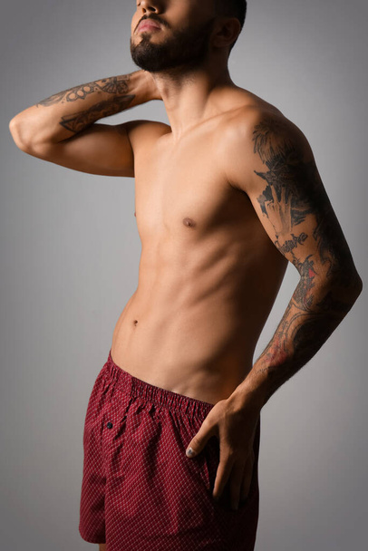 Handsome young man in underwear on grey background - Foto, Imagem