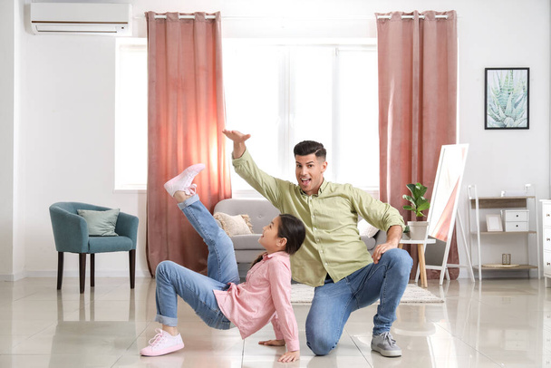 Man and his little daughter dancing at home - Fotoğraf, Görsel
