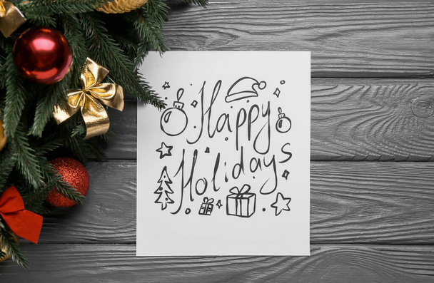 Text HAPPY HOLIDAYS and Christmas decor on dark wooden background - Photo, Image
