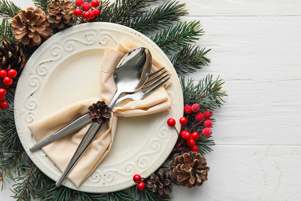 Beautiful Christmas table setting with decor on light wooden background - Foto, immagini