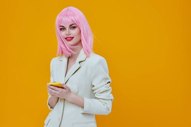 smiling pretty woman pink wig suit phone technology - Foto, Imagen