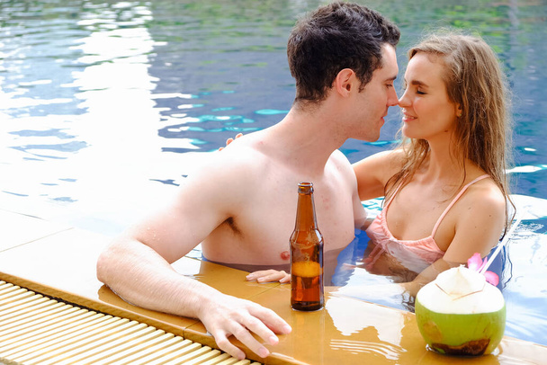 Portrait couple in love, sexy bikini poolside party enjoy having fun in swimming pool, happy life on summer season - Foto, Imagem