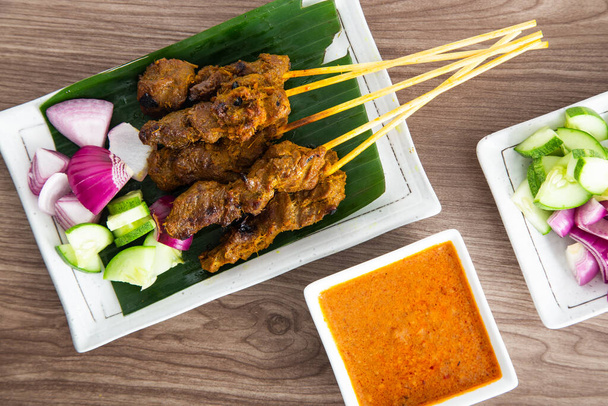 Malaysian beef satay with delicious peanut sauce. famous food in Southeast Asia. - Photo, Image