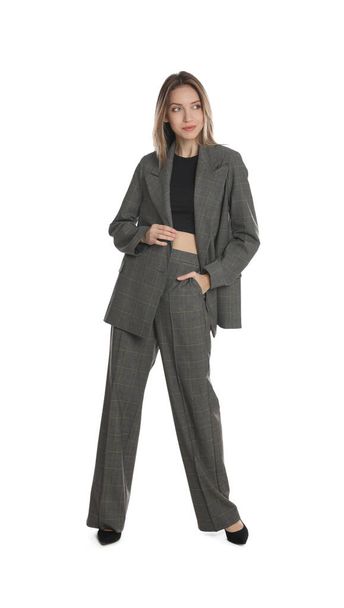 Full length portrait of beautiful young woman in fashionable suit on white background. Business attire - Fotó, kép