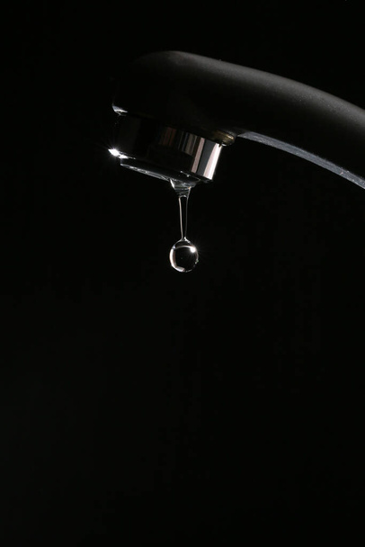 Failure of pure tap water on a black background  - Fotó, kép