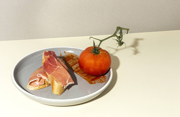 Traditional Spanish Iberian Serrano Ham with tomato. Parma ham Italian antipasto - Фото, зображення
