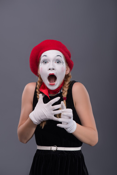 Waist-up portrait of young mime girl showing something - Fotó, kép