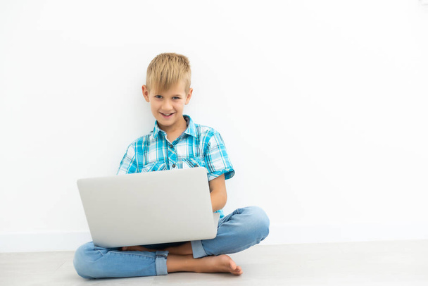 child looks carefully a video on the pc isolated on white - Photo, image