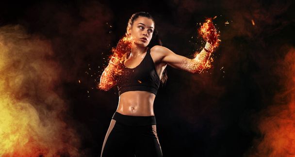 Woman boxer on black background in the fire. Boxing and fitness concept. - Fotoğraf, Görsel