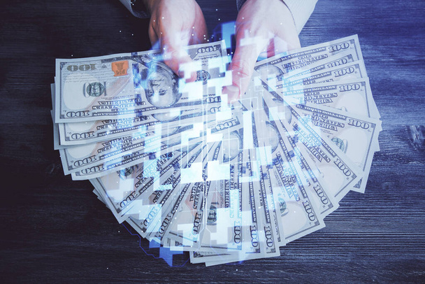 Multi exposure of technology drawing hologram and us dollars bills and man hands. Data concept - Foto, Bild