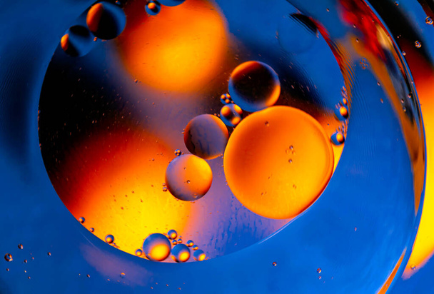 Abstract background with bright circles. Colorful image, drops of oil on the water. Liquid abstraction.  - Photo, image