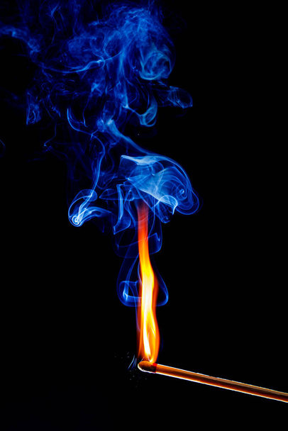 llama y humo de un fósforo sobre fondo negro - Foto, Imagen