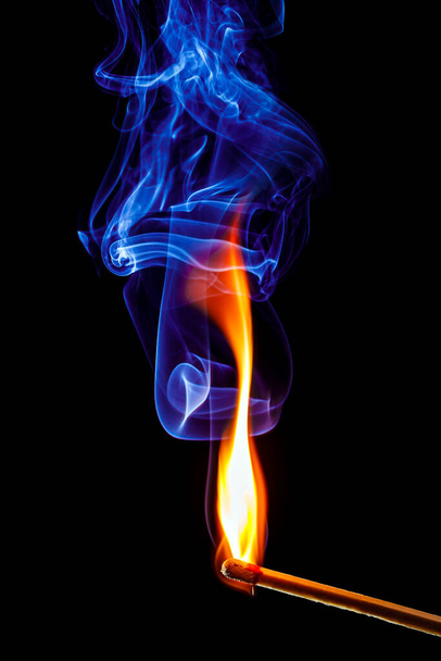 полум'я і дим сірникової палички на чорному фоні
 - Фото, зображення