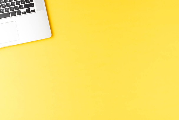 Elegant laptop on yellow table. Office desktop - Fotografie, Obrázek