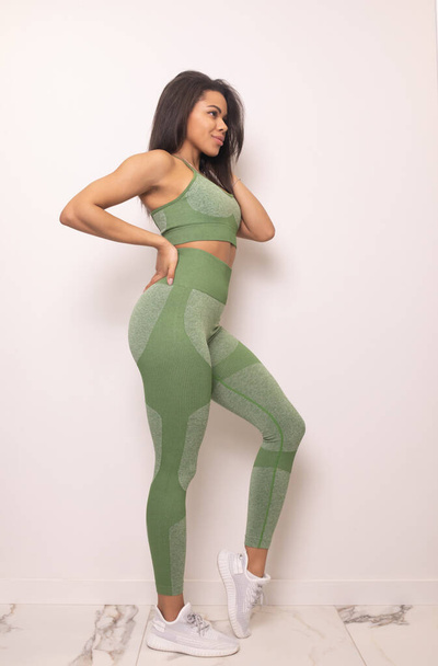 full length view of beautiful young fit african american woman in sportswear posing in studio - Zdjęcie, obraz
