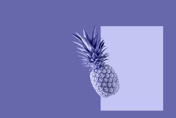 Fresh juicy tropical fruit pineapple flying isolated on violet background. Single whole pineapple falling. Creative card in trendy color 2022 Very Peri. - Photo, Image