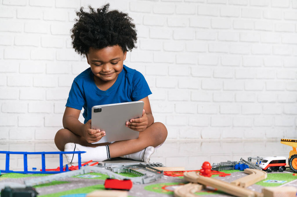 Happy black people African American child play tablet with toy at home - Fotoğraf, Görsel