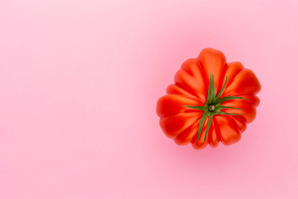 Tomato on the color background. - Фото, изображение
