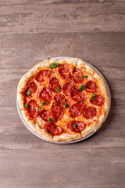 details of tasty fresh baked pesto spicy salami pizza - Foto, imagen