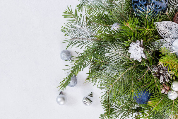 Fir branches, thuja branch, pine cones, and christmas ball on white background. - Photo, Image